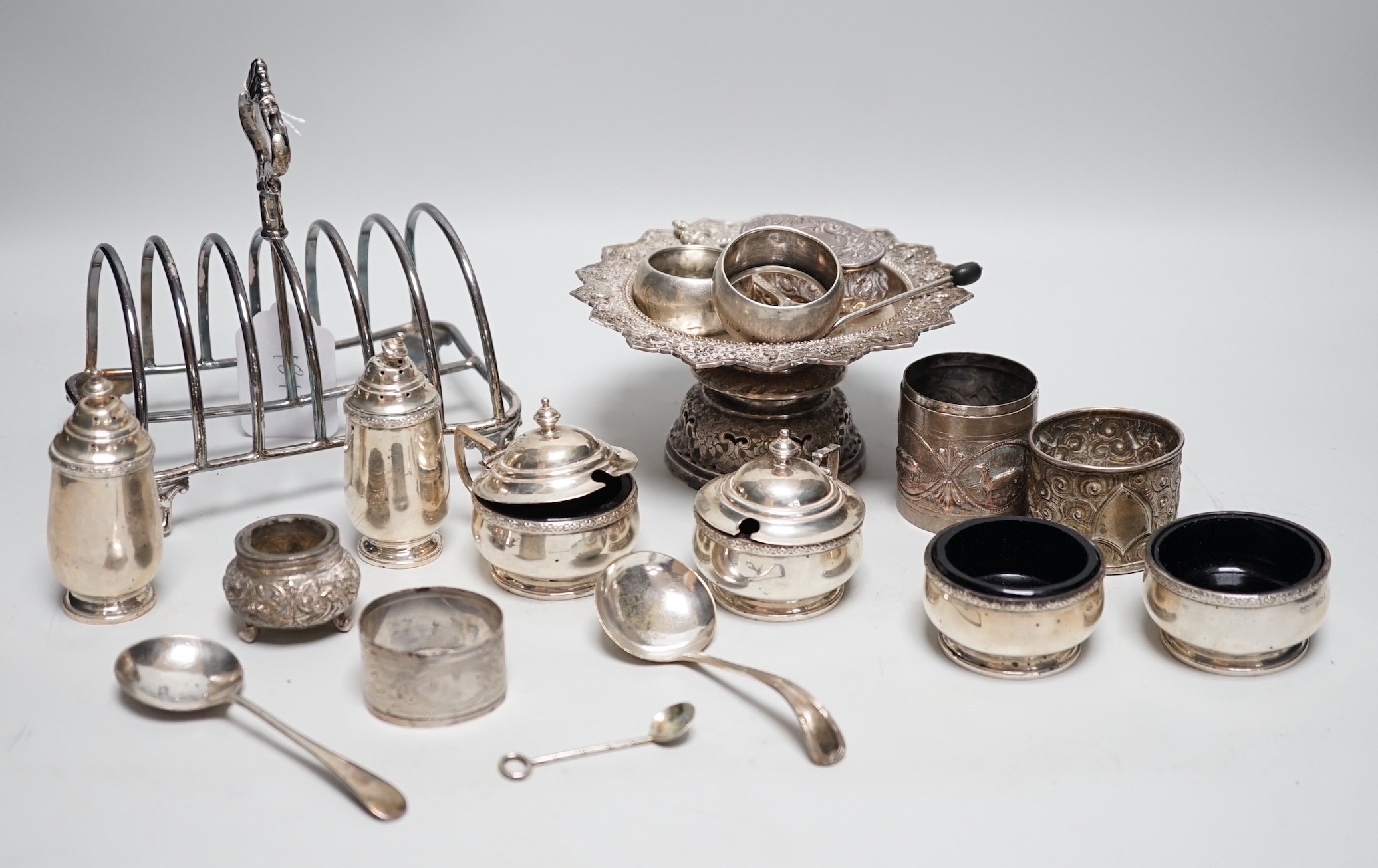 A George IV silver seven bar toast rack, by Robinson, Edkins & Aston, Birmingham, 1827, length 15.7cm, a George V silver six piece condiment set, Mappin & Webb, Birmingham, 1929, a silver coffee spoon and repousse box, t